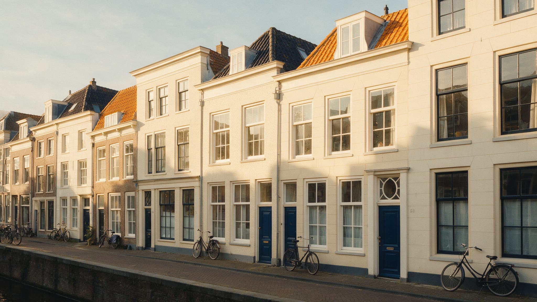 Nederlandse stadsstraat met historische gevels bij gouden licht